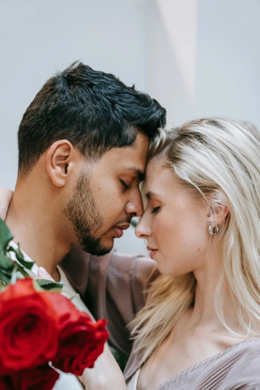 a man standing next to a woman holding a bouquet of red roses, trending on pexels, romanticism, eyes in forehead, dating app icon, jovana rikalo, ash thorp khyzyl saleem