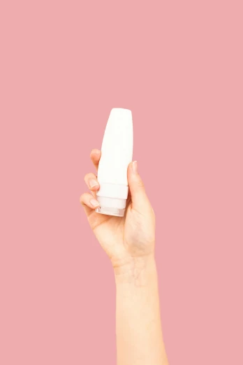a hand holding a bottle of deodorant on a pink background, by Anita Malfatti, plasticien, show, isolate translucent, large tall, rectangle