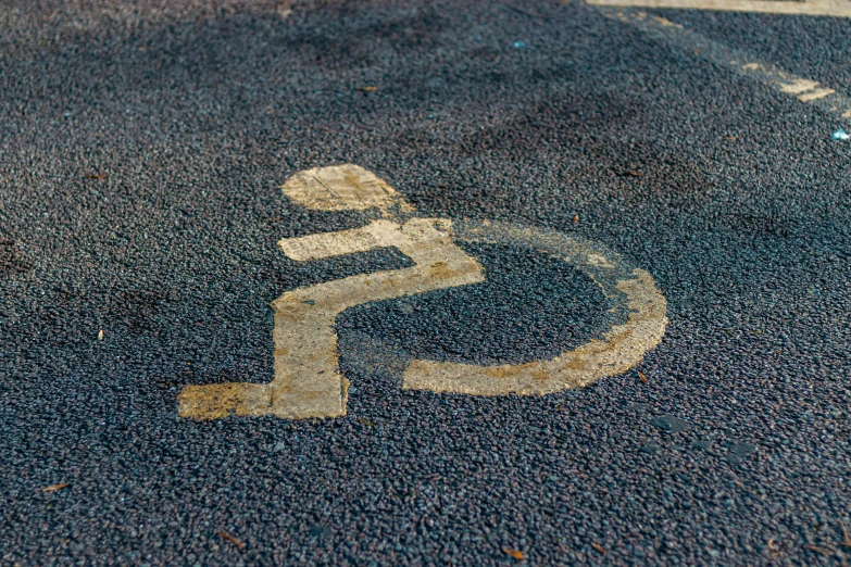 a handicap sign painted on the side of a road, unsplash, auto-destructive art, square, splash image, gravels around, high-quality photo