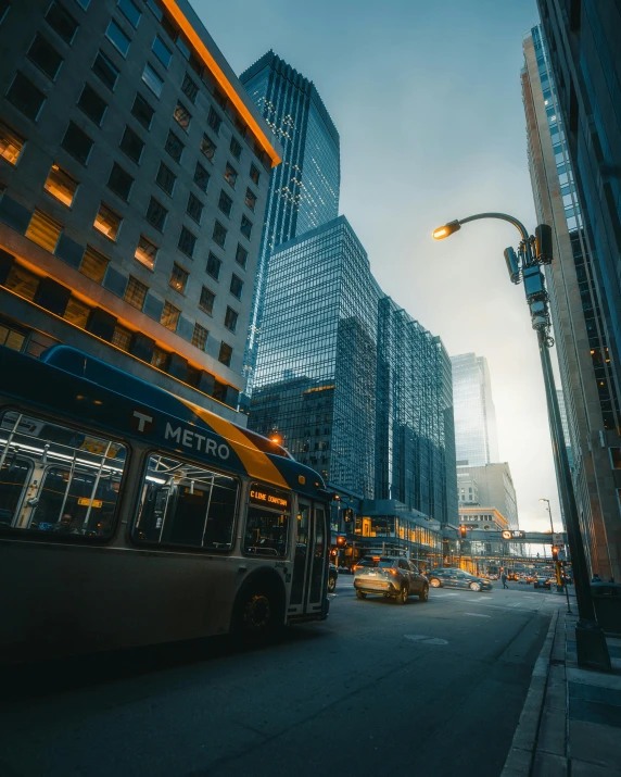 a bus driving down a city street next to tall buildings, pexels contest winner, chicago, 2 0 2 2 photo, snapchat photo, street lighting