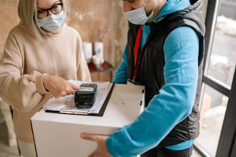 a couple of people that are standing in front of a box, pexels contest winner, medical supplies, thumbnail, document photo, handheld