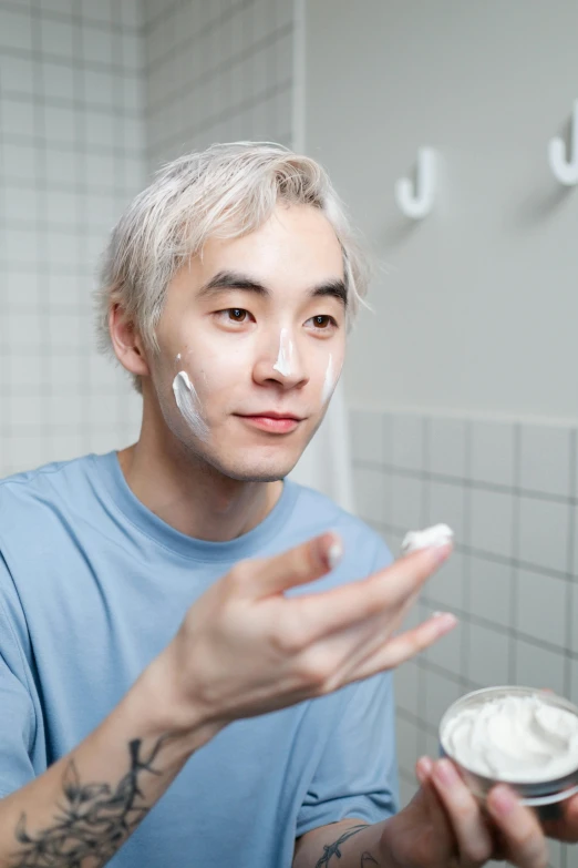 a man is shaving his face in the bathroom, by Jang Seung-eop, white-hair pretty face, hand on his cheek, avatar image, college