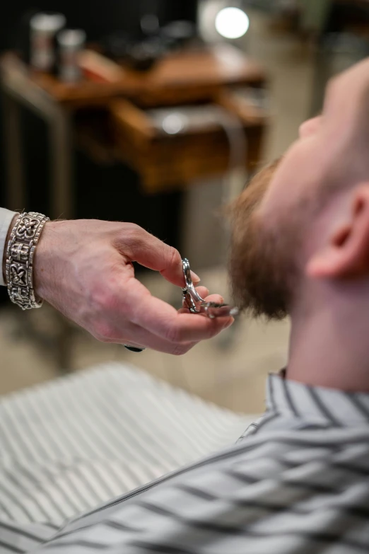 a man getting his hair cut at a barber shop, by Adam Marczyński, silver full beard, thumbnail, plating, wearing collar