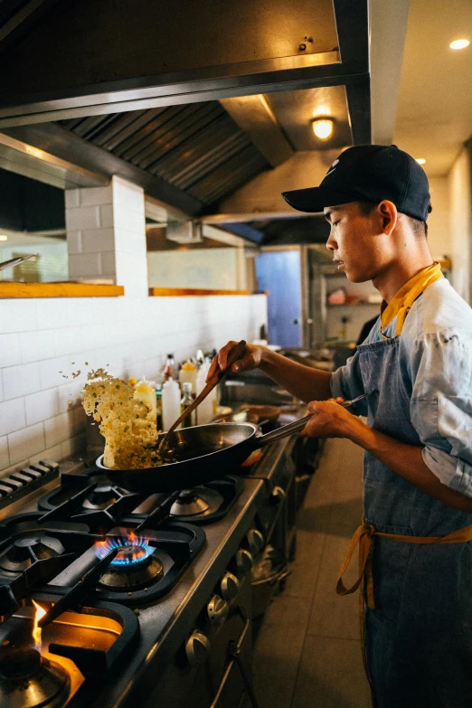 a man standing in a kitchen preparing food, jonny wan, yellow seaweed, thumbnail, restaurant