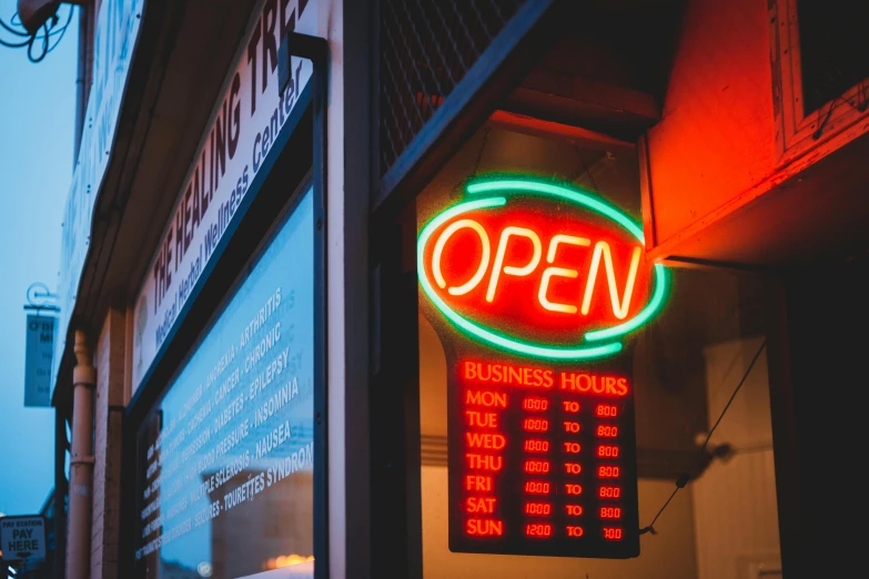 a neon sign hanging from the side of a building, pexels, convenience store, open vault, thumbnail, after hours