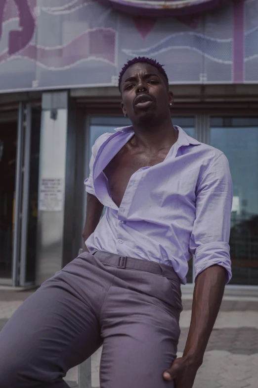 a man sitting on a bench in front of a building, an album cover, inspired by David Bailly, trending on pexels, renaissance, purple skin color, model standing pose, grey skin, maria borges