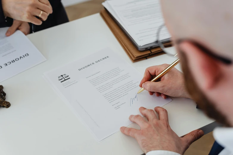 a couple of people that are sitting at a table, pexels contest winner, private press, black ball pen on white paper, lawyer clothing, thumbnail, ad image