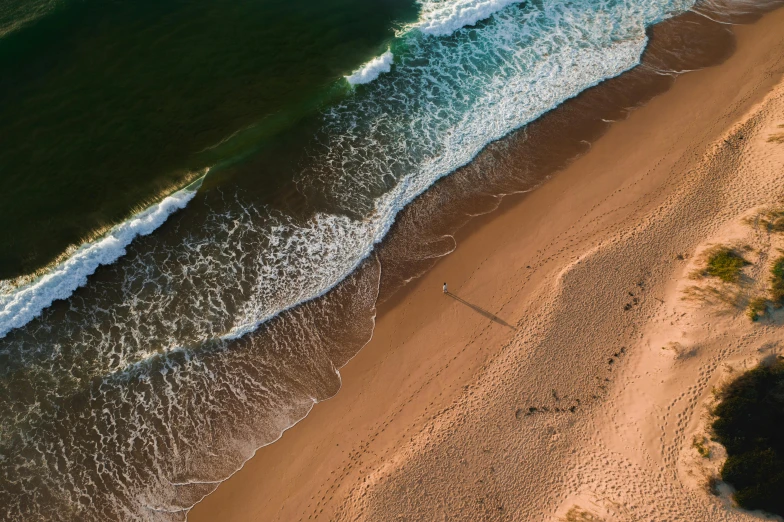 a large body of water next to a sandy beach, by Niko Henrichon, pexels contest winner, bird's eye, 15081959 21121991 01012000 4k, “ iron bark, ultra realistic 8k octan photo