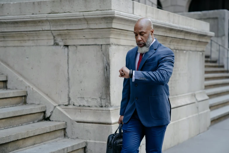 a man in a blue suit and red tie, inspired by William H. Mosby, pexels contest winner, renaissance, humans of new york, grey beard, walking to work, wearing a watch