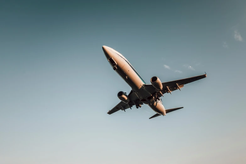 a large jetliner flying through a blue sky, pexels contest winner, hurufiyya, avatar image, landing gear, thumbnail, tyler west