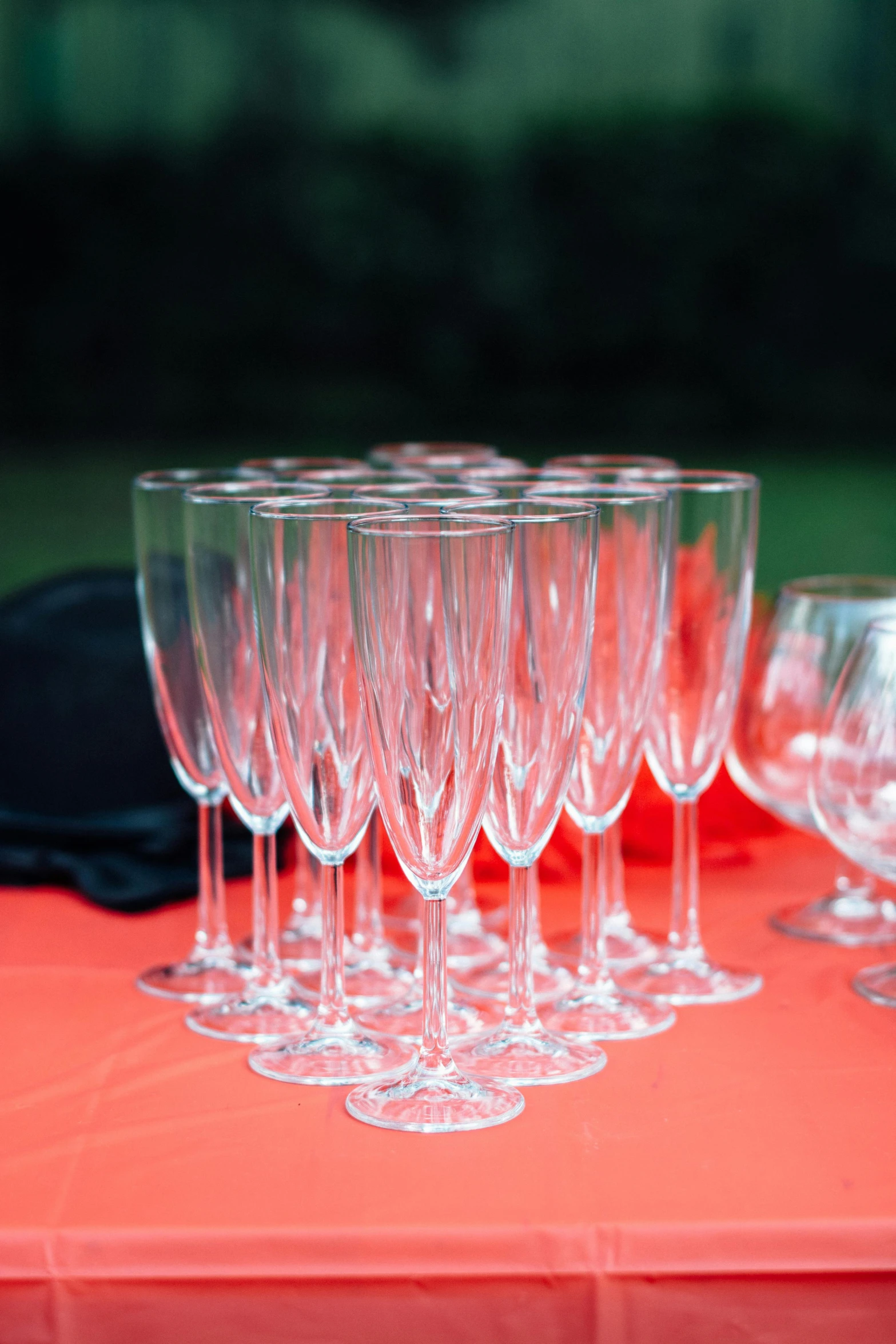 a bunch of wine glasses sitting on top of a table, on a velvet table cloth, drinking champagne, black rimmed glasses, up close