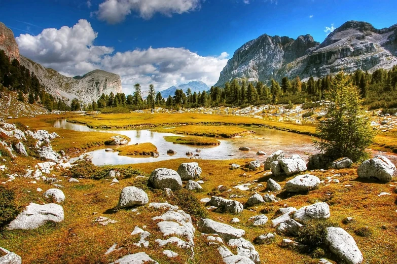 a field of grass and rocks with mountains in the background, pexels contest winner, lago di sorapis, autumn, high quality product image”, yosemite