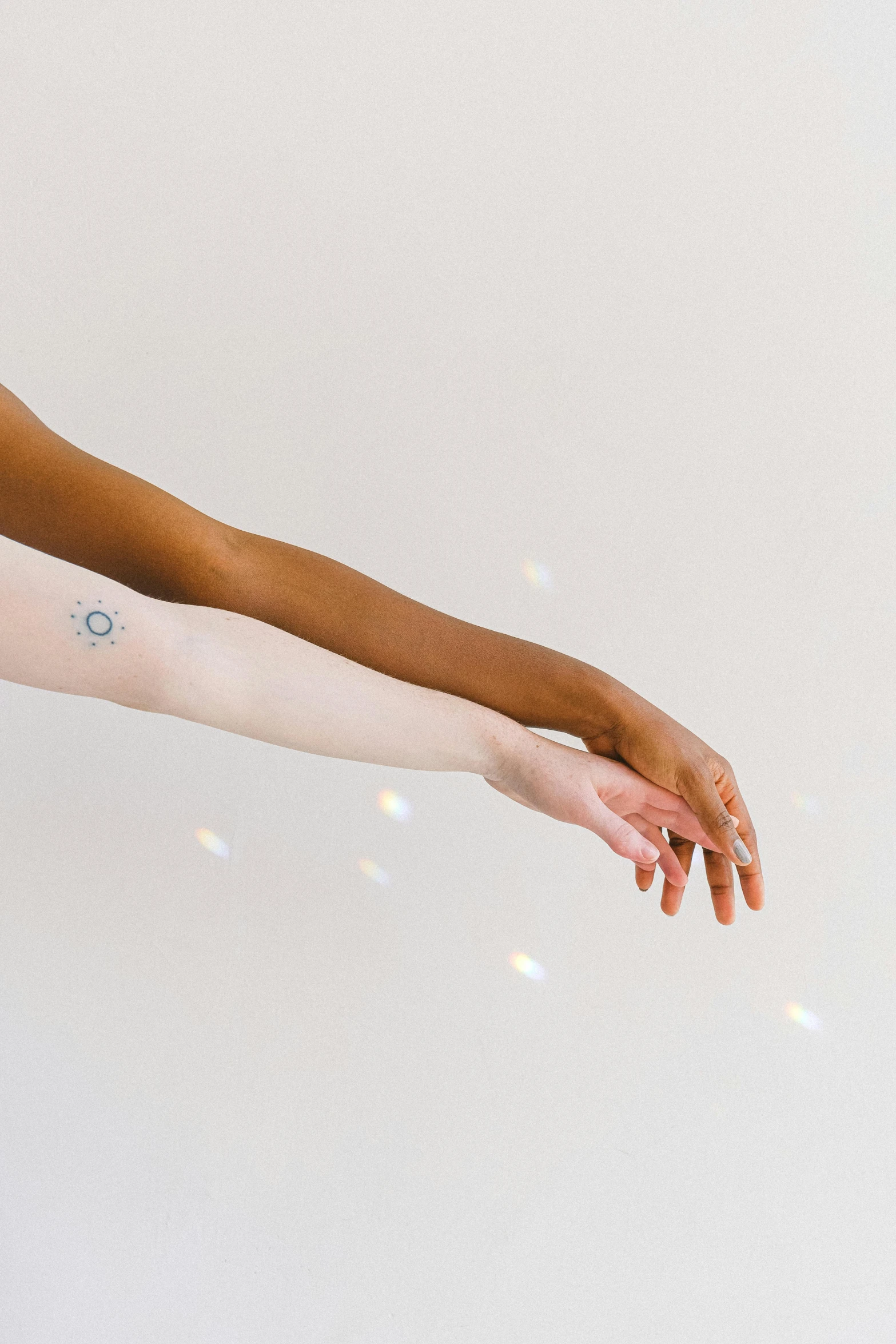 a woman with a tattoo on her arm, trending on pexels, light and space, reaching out to each other, varying ethnicities, wearing white leotard, glowing aesthetic