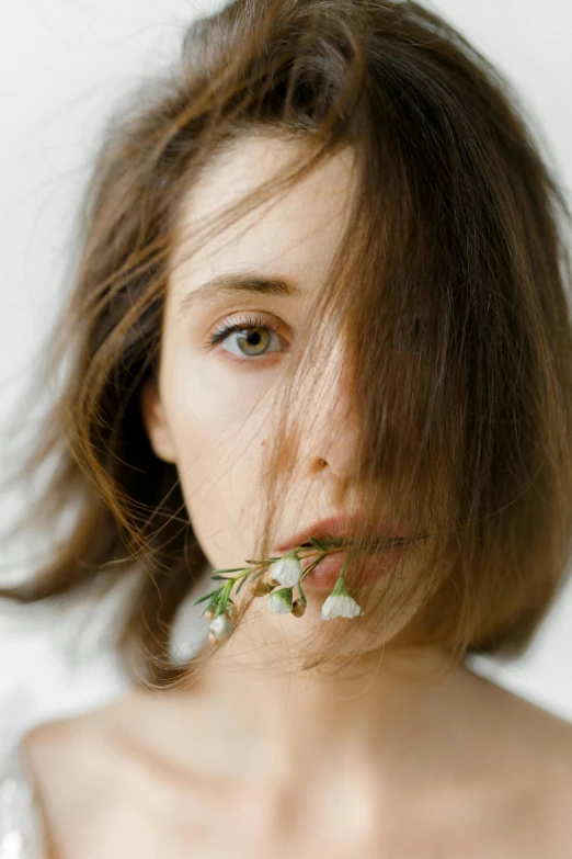 a woman with a flower in her mouth, inspired by Elsa Bleda, unsplash, renaissance, messy brown hair, with a white background, thinning hair, ignant