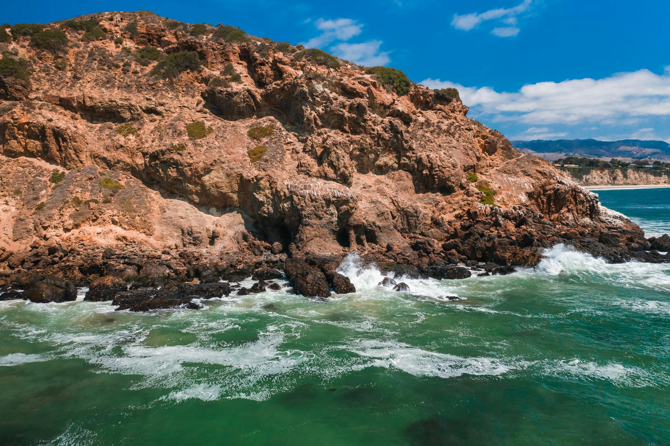 a large body of water next to a rocky shore, pexels contest winner, hollister ranch, steep cliffs, slide show, thumbnail