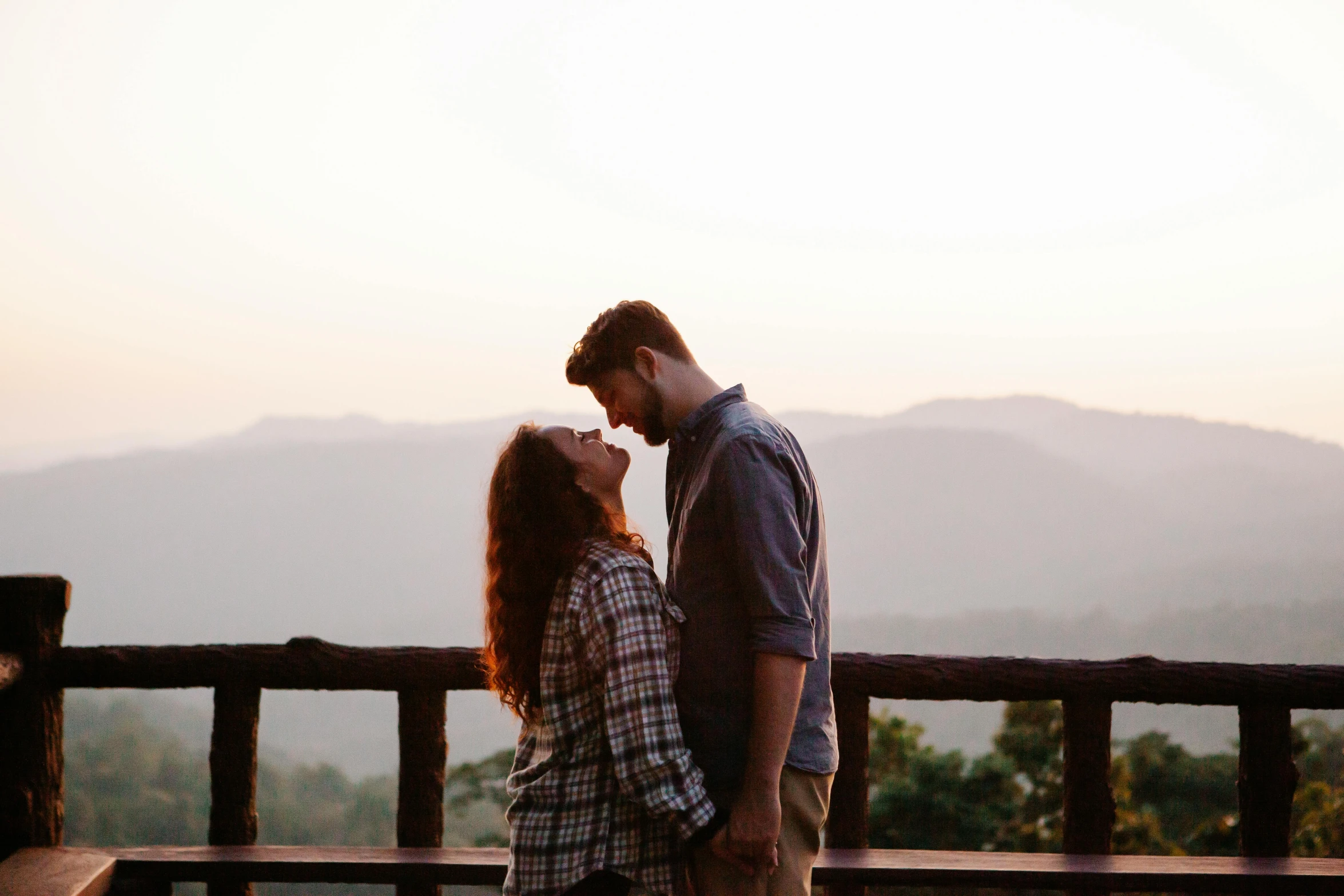 a man and woman standing next to each other on a bench, pexels contest winner, romanticism, girl standing on mountain, profile image, natural lights, making out