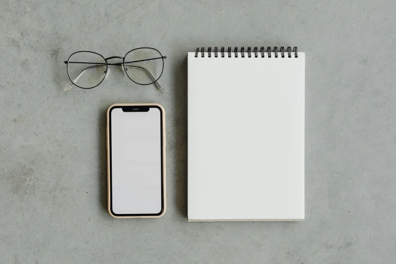 a notepad, glasses and a smart phone on a table, trending on pexels, postminimalism, square rimmed glasses, with a white, 1 2 9 7, high-quality photo