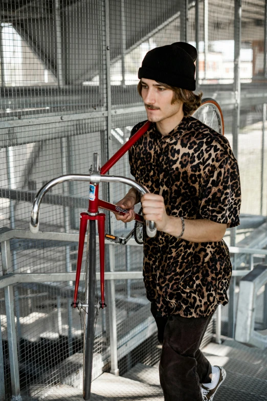 a man that is standing next to a bike, wearing animal skin clothing, profile image, wearing skate helmet, frank dillane