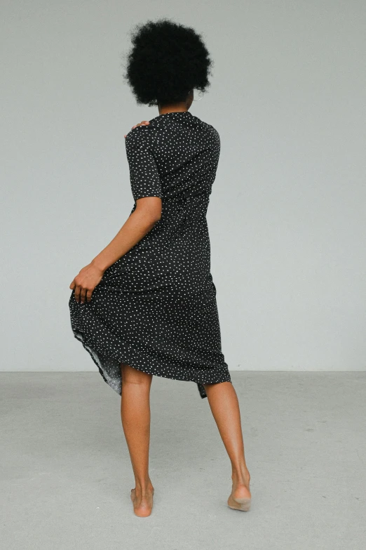 the back of a woman in a black and white dress, inspired by Johann Christian Brand, unsplash, varying dots, back view », cut out, soft silk dress