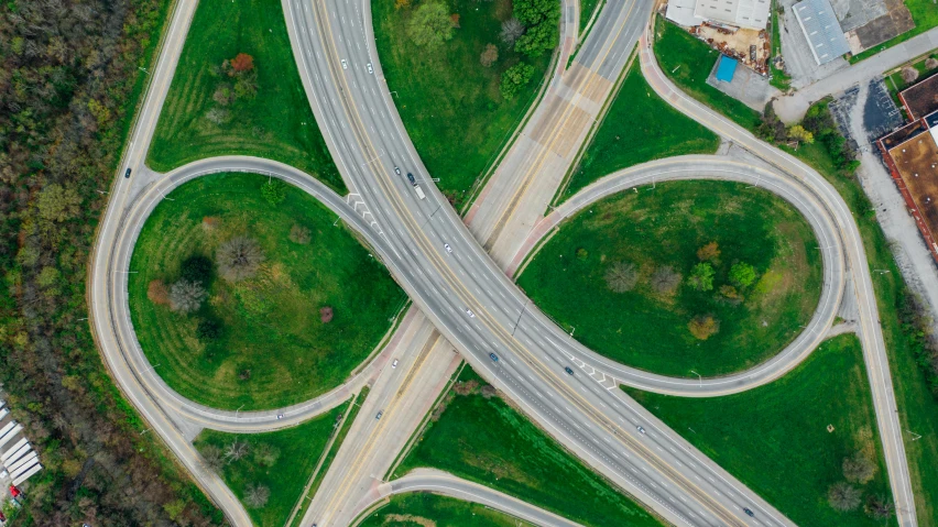 an aerial view of a highway intersection, by Carey Morris, pexels contest winner, visual art, green spaces, from wheaton illinois, thumbnail, interesting background