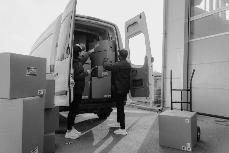 two men unloading boxes into a van, a black and white photo, unsplash, jiyun chae, all from the group nct, high detail!!, donglu yu