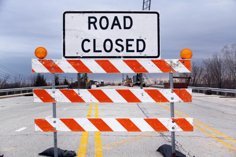 a road closed sign sitting on the side of a road, unsplash, happening, 2 5 6 x 2 5 6 pixels, construction, background image, tv still