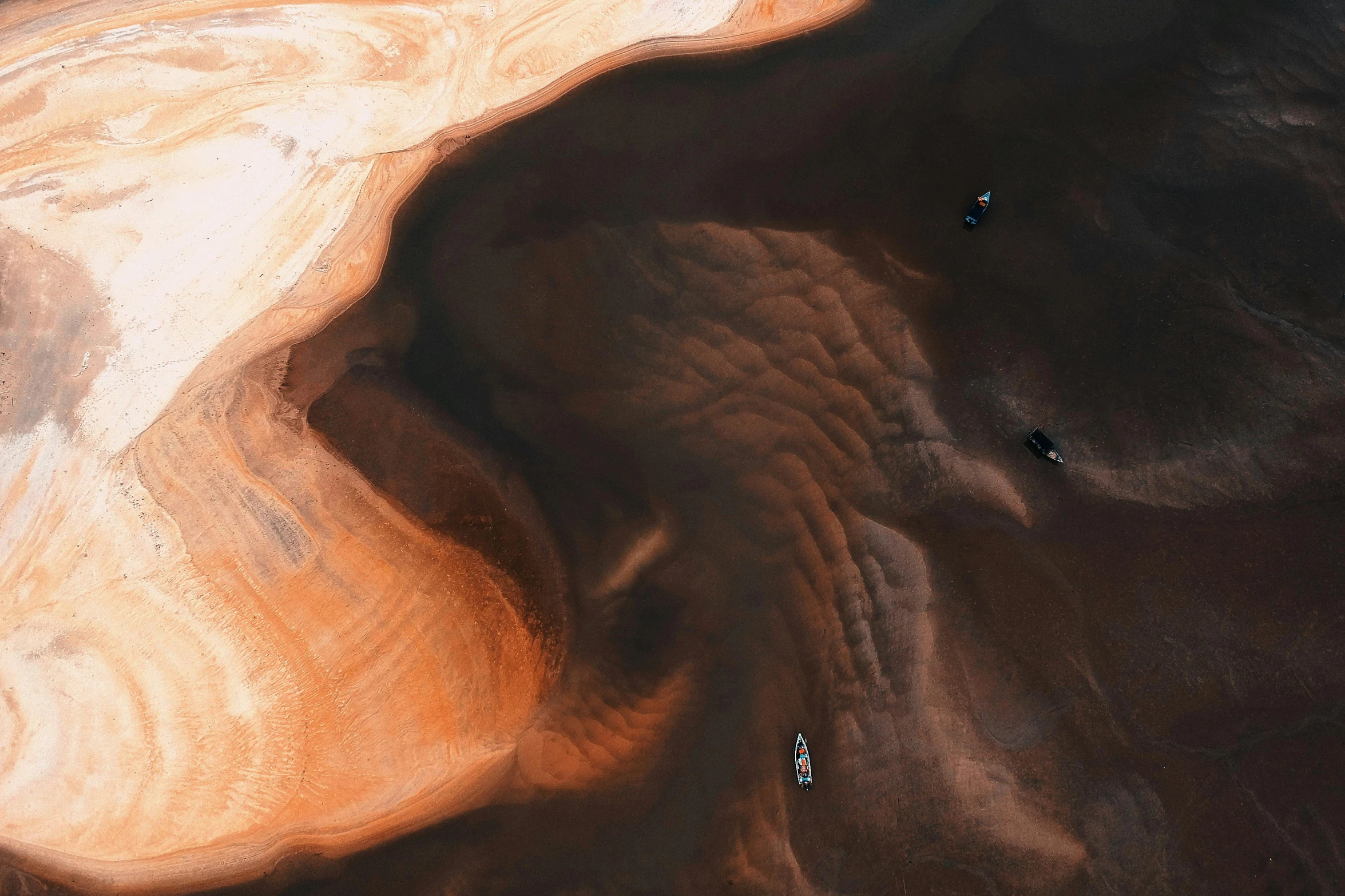 a couple of boats floating on top of a body of water, by Dan Christensen, pexels contest winner, conceptual art, the australian desert, mining, photography ultrafine detail, smooth contours