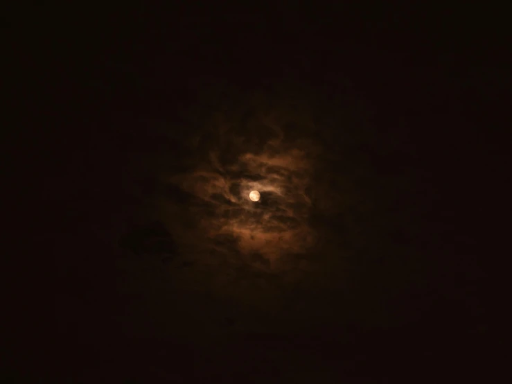 a full moon is seen through the clouds, an album cover, flickr, 8 k. volumetric lighting. dark, brown, ☁🌪🌙👩🏾, zoomed out photography