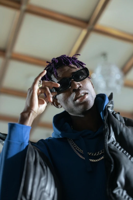 a man with purple hair smoking a cigarette, an album cover, trending on pexels, young thug, wearing oakley sunglasses, full frame image, young lady