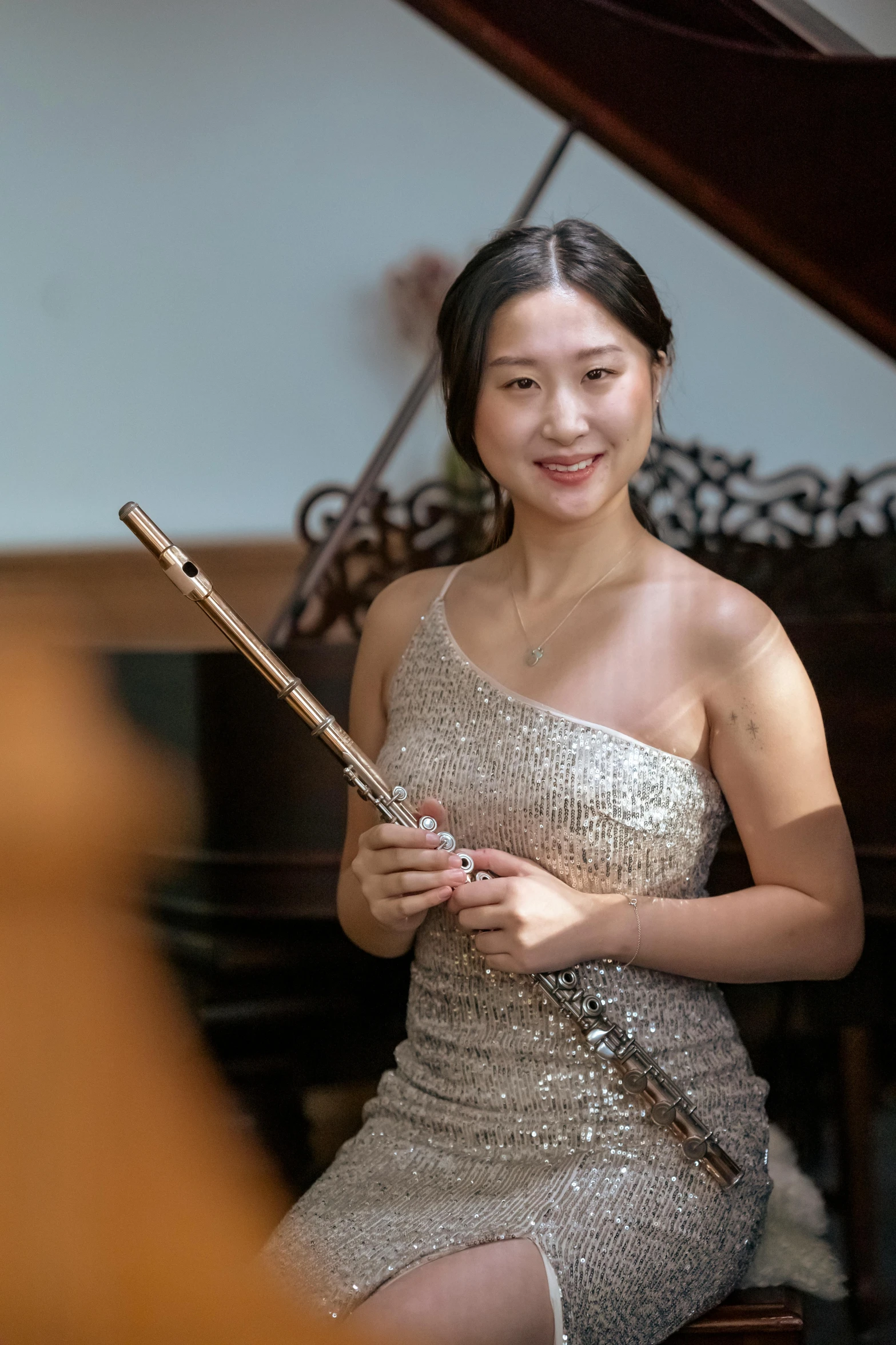 a woman sitting in front of a piano holding a flute, inspired by Zheng Xie, portrait image, ruan jia and brom, no cropping, performing