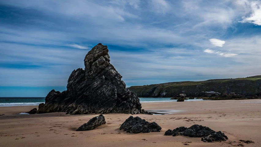 a large rock sitting on top of a sandy beach, by Andrew Allan, pexels contest winner, baroque, ultrawide image, on the beach at noonday, merlin, beach is between the two valleys