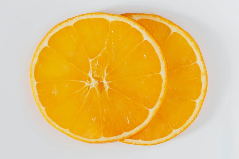 two slices of orange on a white surface, by Carey Morris, pexels, 🦩🪐🐞👩🏻🦳, round-cropped, orange: 0.5, detailed product image