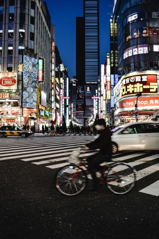 a person riding a bike on a city street, a picture, inspired by Kanō Naizen, unsplash contest winner, neon signs in background, ethnicity : japanese, square, superwide shot