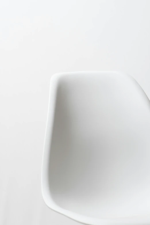 a white chair against a white wall, inspired by Matteo Pérez, unsplash, dynamic closeup, sharp nose with rounded edges, miniature product photo, back - view