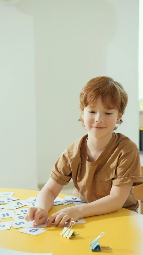 a little boy that is sitting at a table, pexels, trading card game, flowing ginger hair, high quality photo, thumbnail