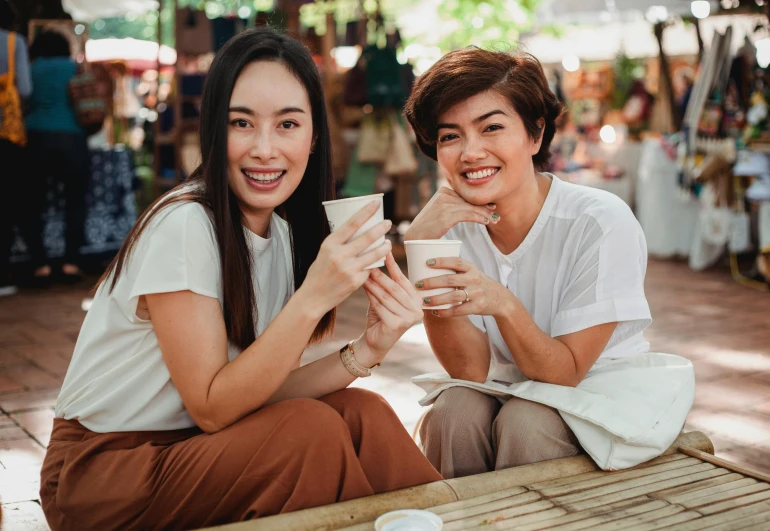 a couple of women sitting next to each other, pexels contest winner, happening, milk and mocha style, avatar image, asian female, family friendly