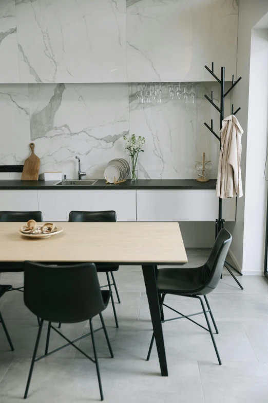 a kitchen with a wooden table and black chairs, pexels contest winner, minimalism, ivory and black marble, full body full height, hunting, complete scene