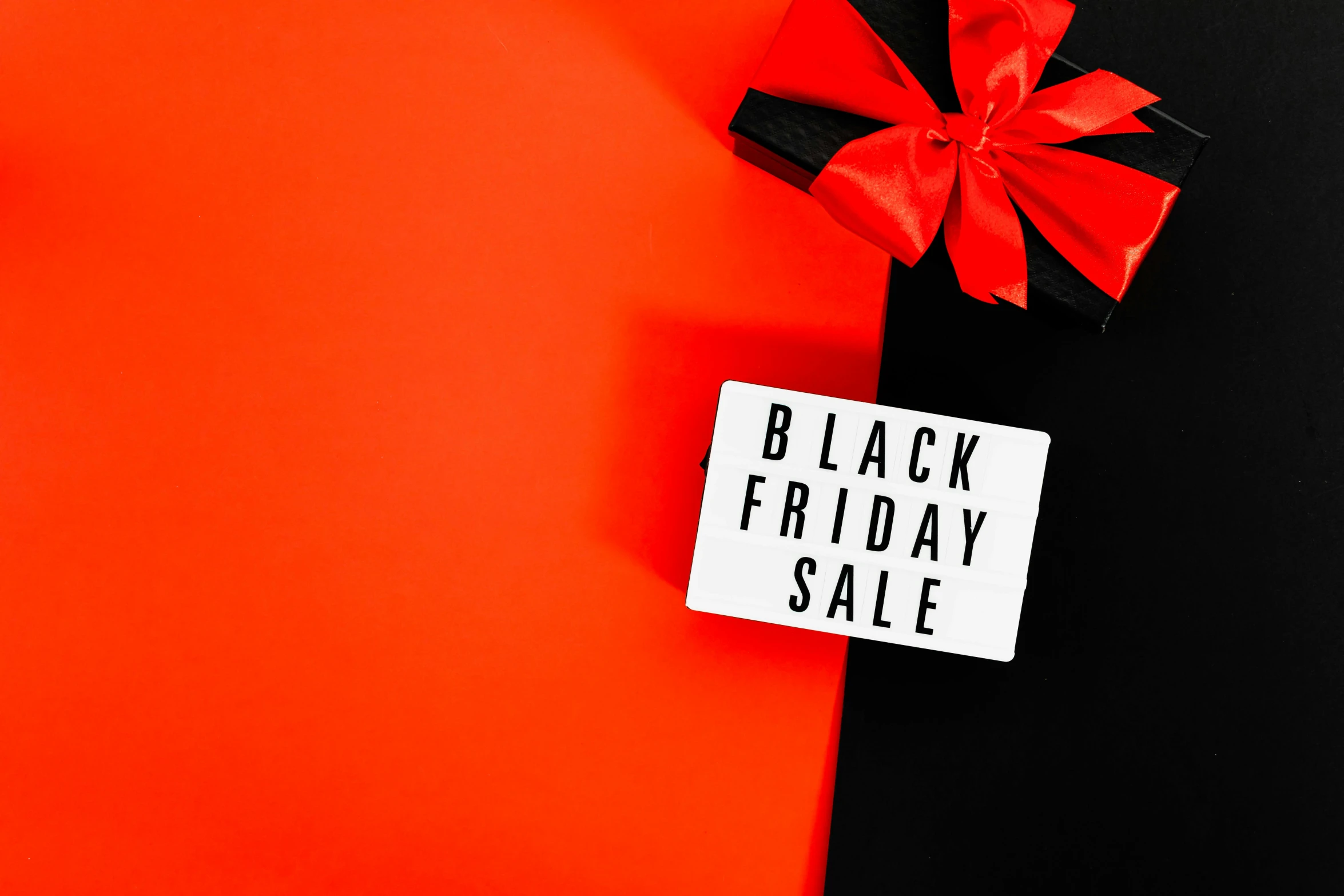 a black friday sale sign with a red bow, trending on unsplash, hurufiyya, 1 6 x 1 6, bottom angle, the black box, half image