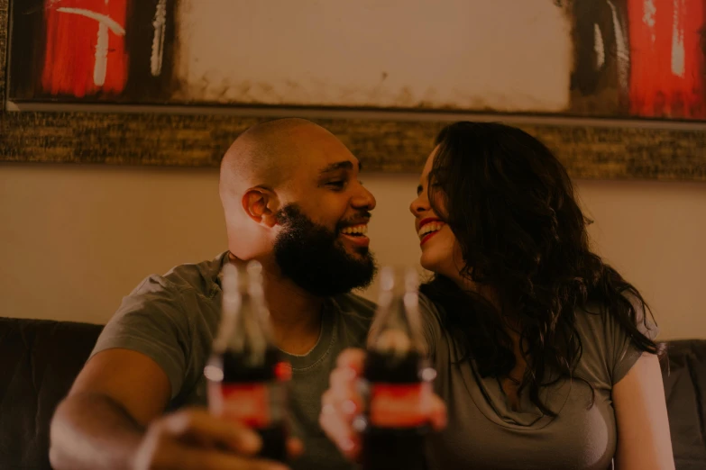 a man and a woman sitting next to each other on a couch, a picture, pexels contest winner, happening, coca cola bottle, with a beard and a black shirt, profile image, happy couple