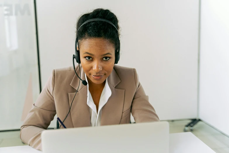 a woman sitting in front of a laptop wearing a headset, pexels, ethiopian, avatar image, professional closeup photo, thumbnail