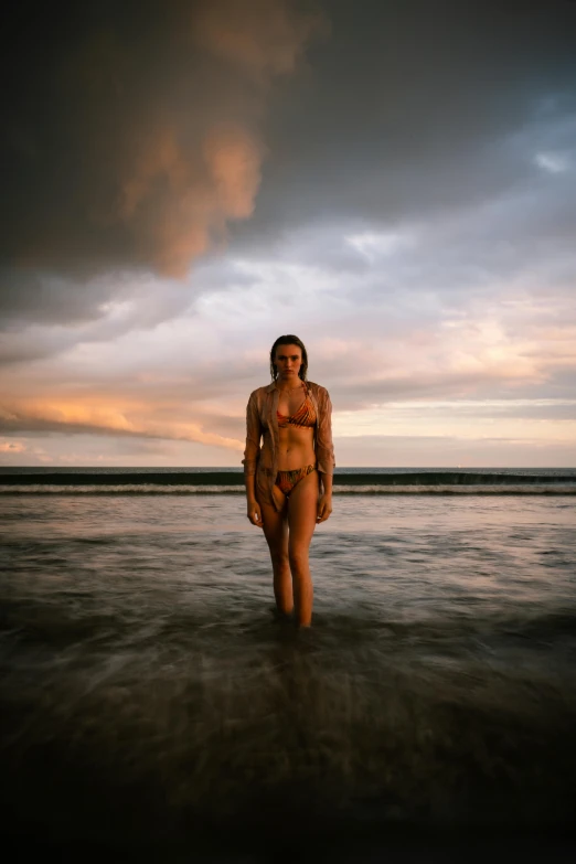 a woman that is standing in the water, by Jessie Algie, on the beach during sunset, wearing loincloth, full body 8k, indonesia