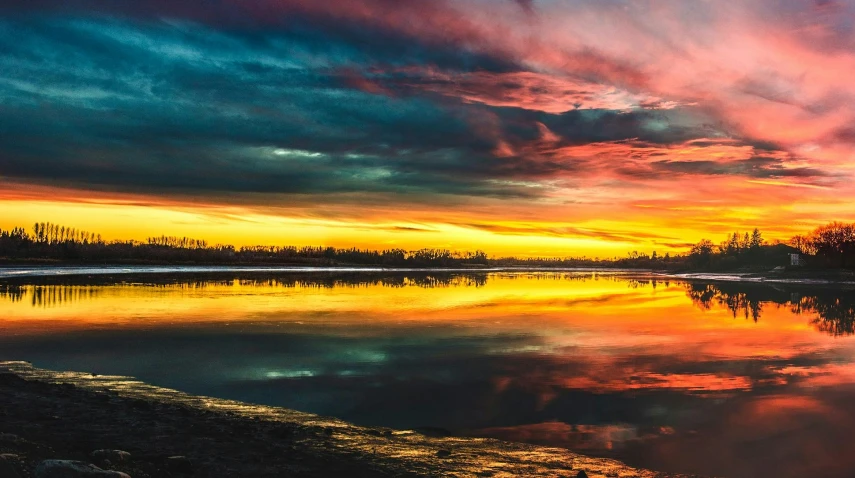 a large body of water with a sunset in the background, by Jan Rustem, pexels contest winner, layers of colorful reflections, panoramic shot, vibrant but dreary gold, instagram post