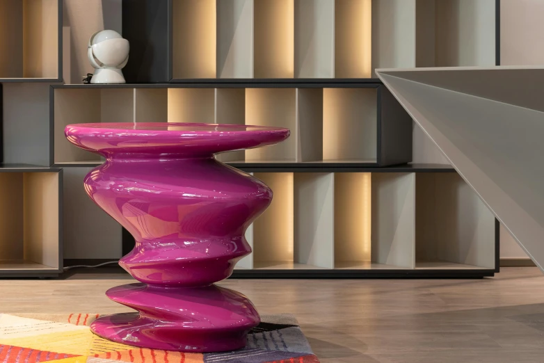 a pink table sitting on top of a wooden floor, an abstract sculpture, inspired by Francesco Furini, purple tornado, lacquered glass, show room scene, regale