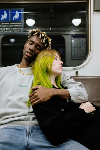 a man and woman sitting next to each other on a subway, inspired by Nan Goldin, trending on pexels, renaissance, bright green hair, adut akech, jesus hugging a woman, yellow and green