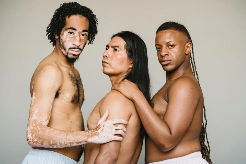 a group of three men standing next to each other, by Ellen Gallagher, unsplash, antipodeans, with brown skin, disrobed, ashteroth, cast