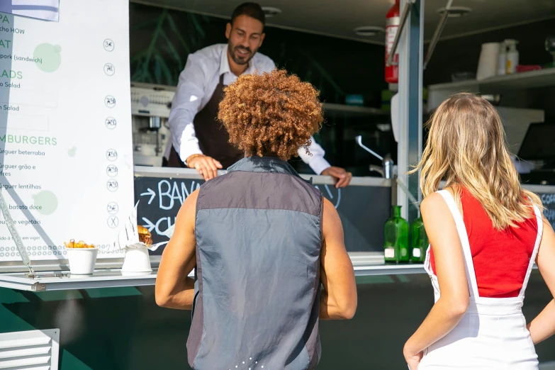 a group of people standing in front of a food truck, bartending, alessandro barbucci, seen from the back, profile image