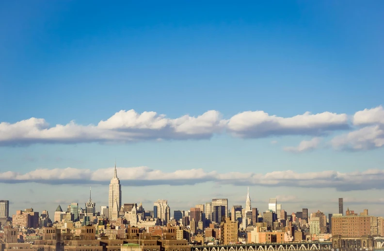 a view of a city from the top of a hill, an album cover, by Carey Morris, pexels contest winner, renaissance, manhattan, light blue sky with clouds, bjarke ingels, 15081959 21121991 01012000 4k