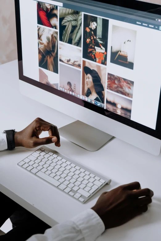 a person sitting at a desk using a computer, trending on pexels, everything fits on the screen, lots of pictures, dark-skinned, white backround