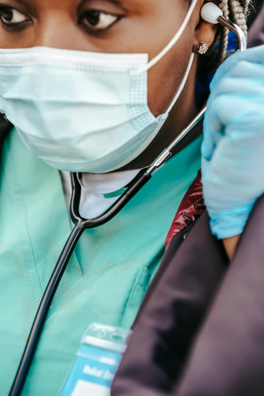 a close up of a person with a stethoscope, a picture, trending on pexels, happening, surgical gown and scrubs on, masked doctors, around a neck, teal color graded