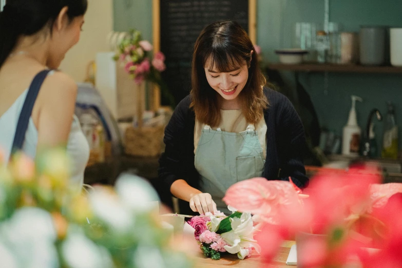 two women are working in a flower shop, inspired by Yukimasa Ida, pexels contest winner, medium closeup, jenny seville, flattened, diy